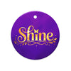 Glossy ceramic Christmas ornament with gold ‘Shine’ lettering on a midnight violet background. Created by Women’s Fiction & Romance Author Juliet Gauvin.