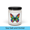 Front view: Juliet’s Butterfly soy candle — 9oz glass jar with butterfly label, Sea Salt and Orchid scent.