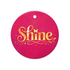 Glossy ceramic Christmas ornament with gold ‘Shine’ lettering on a mystic magenta background. Created by Women’s Fiction & Romance Author Juliet Gauvin.