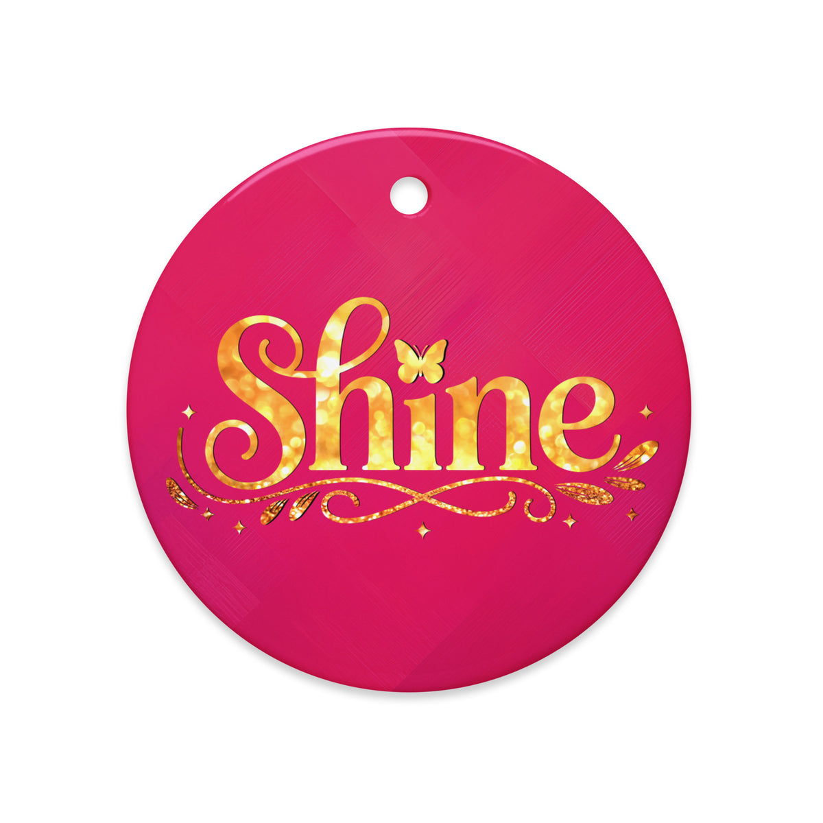 Glossy ceramic Christmas ornament with gold ‘Shine’ lettering on a mystic magenta background. Created by Women’s Fiction & Romance Author Juliet Gauvin.