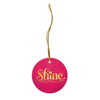 Glossy ceramic Christmas ornament with gold ‘Shine’ lettering on a mystic magenta background, full gold string. Created by Women’s Fiction & Romance Author Juliet Gauvin.