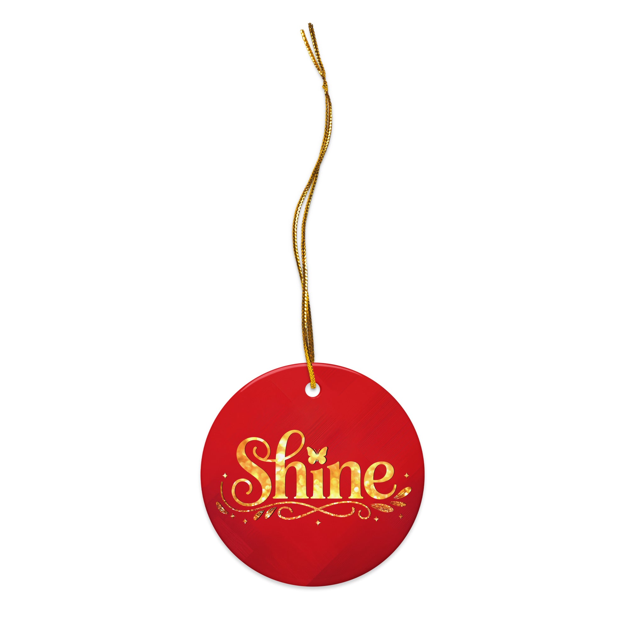 Glossy ceramic Christmas ornament with gold ‘Shine’ lettering on a mags red background, full gold string. Created by Women’s Fiction & Romance Author Juliet Gauvin.